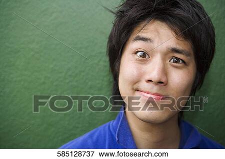 Portrait of a young man making a face View Large Photo Image Stock Photo - Portrait of a young man making a face. Fotosearch