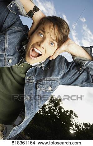 Picture - Portrait of a young man shouting. Fotosearch