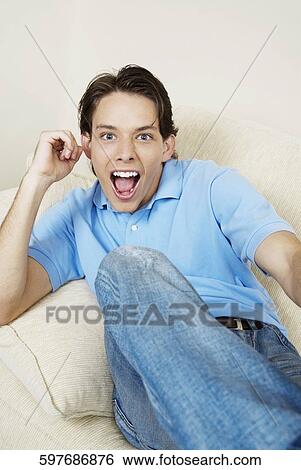 Portrait of a young man with his mouth open View Large Photo Image Stock Photograph - Portrait of a young man with his mouth open. Fotosearch