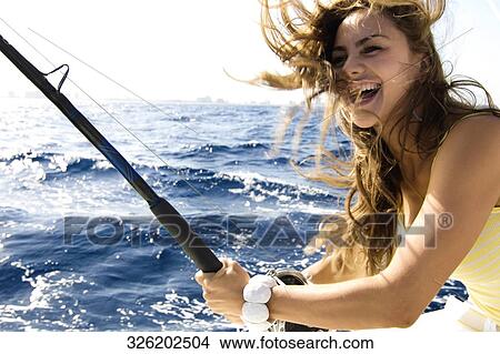 Portrait of a young woman fishing and smiling View Large Photo Image Picture - Portrait of a young woman fishing and smiling. Fotosearch