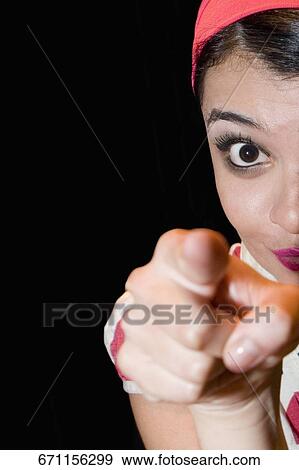 Portrait of a young woman gesturing View Large Photo Image Stock Photo - Portrait of a young woman gesturing. Fotosearch