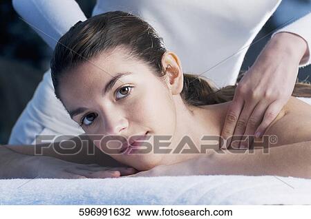 Portrait of a young woman getting massage from a massage therapist View Large Photo Image Stock Image - Portrait of a young woman getting massage from a massage therapist. Fotosearch