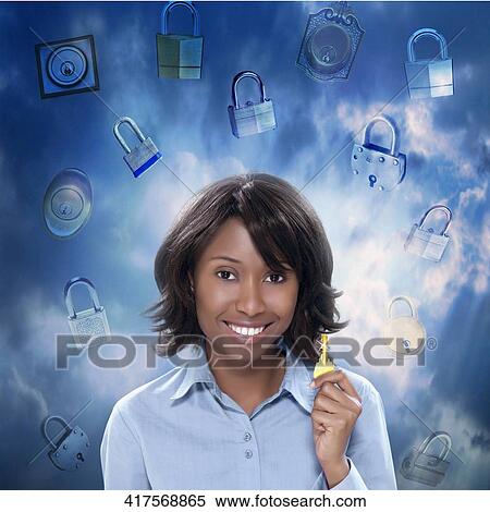 Portrait of a young woman holding a key and smiling View Large Photo Image Stock Photography - Portrait of a young woman holding a key and smiling. Fotosearch