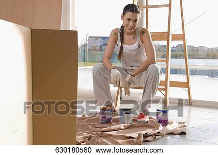 Portrait of a young woman holding a paintbrush View Large Photo Image Stock Image - Portrait of a young woman holding a paintbrush. Fotosearch