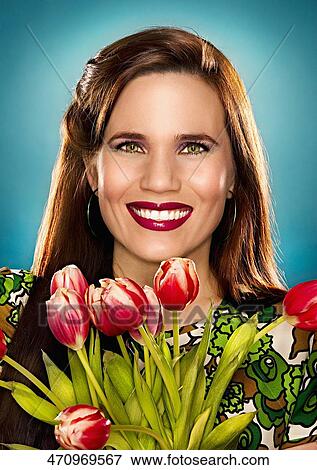 Portrait of a young woman holding a bunch of flowers View Large Photo Image Stock Photo - Portrait of a young woman holding a bunch of flowers. Fotosearch