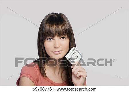 Portrait of a young woman holding one dollar bills and thinking View Large Photo Image Stock Image - Portrait of a young woman holding one dollar bills and thinking. Fotosearch