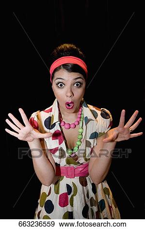 Stock Photo - Portrait of a young woman looking shocked. Fotosearch
