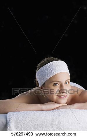 Portrait of a young woman lying on a massage table View Large Photo Image Stock Image - Portrait of a young woman lying on a massage table. Fotosearch