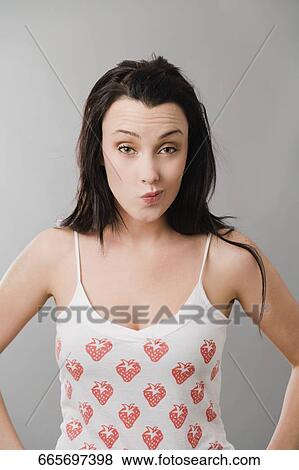 Stock Photo - Portrait of a young woman making a face. Fotosearch