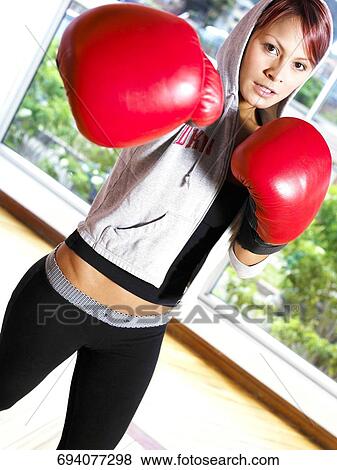 Portrait of a young woman practicing boxing View Large Photo Image Stock Photo - Portrait of a young woman practicing boxing. Fotosearch