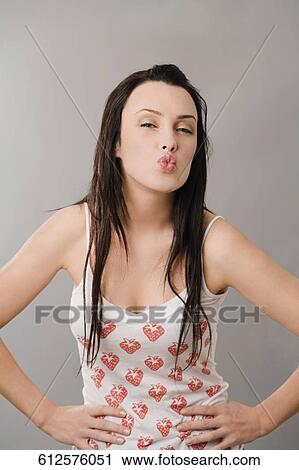 Portrait of a young woman puckering her lips View Large Photo Image Stock Image - Portrait of a young woman puckering her lips. Fotosearch