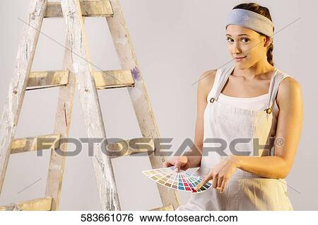 Portrait of a young woman showing color swatch View Large Photo Image Stock Photograph - Portrait of a young woman showing color swatch. Fotosearch