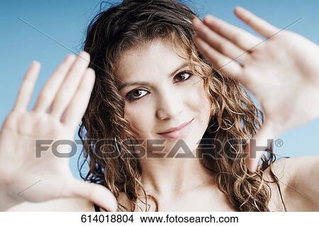 Portrait of a young woman showing her palms View Large Photo Image Picture - Portrait of a young woman showing her palms. Fotosearch