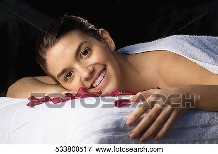 Portrait of a young woman smiling View Large Photo Image Stock Photo - Portrait of a young woman smiling. Fotosearch