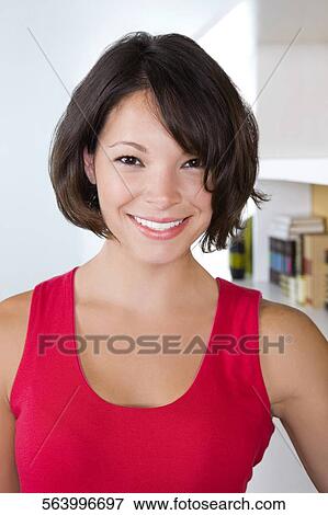 Portrait of a young woman smiling View Large Photo Image Stock Photo - Portrait of a young woman smiling. Fotosearch