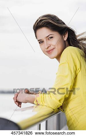 Stock Photograph - Portrait of a young woman smiling. Fotosearch