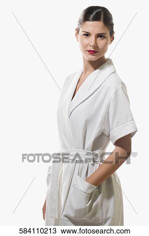 Portrait of a young woman standing with her hand in her pocket View Large Photo Image Stock Image - Portrait of a young woman standing with her hand in her pocket. Fotosearch