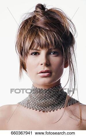 Portrait of a young woman wearing a necklace View Large Photo Image Stock Image - Portrait of a young woman wearing a necklace. Fotosearch