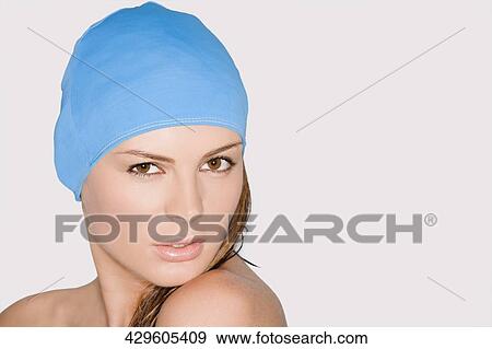Portrait of a young woman wearing swimming cap View Large Photo Image Stock Photo - Portrait of a young woman wearing swimming cap. Fotosearch