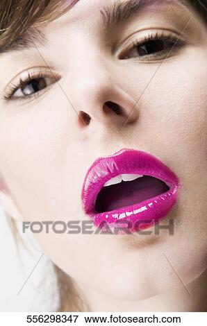 Stock Photo - Portrait of a young woman with her mouth open. Fotosearch