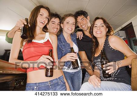 Portrait of five friends smiling at a bar counter View Large Photo Image Stock Image - Portrait of five friends smiling at a bar counter. Fotosearch