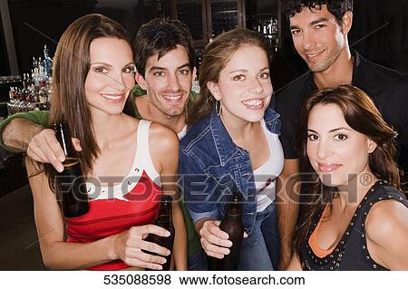 Portrait of five friends smiling at a bar counter View Large Photo Image Stock Photo - Portrait of five friends smiling at a bar counter. Fotosearch