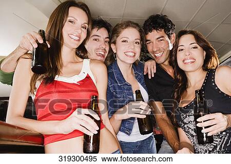 Portrait of five friends smiling at a bar counter View Large Photo Image Stock Photography - Portrait of five friends smiling at a bar counter. Fotosearch