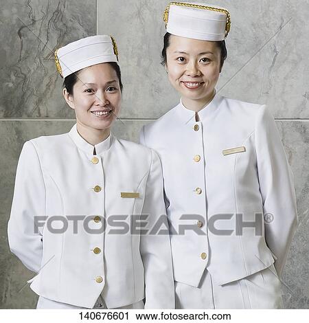 Stock Image - Portrait of two cabin crew smiling. Fotosearch