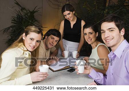 Portrait of two couples with a waitress in a cafe and smiling View Large Photo Image Stock Image - Portrait of two couples with a waitress in a cafe and smiling. Fotosearch