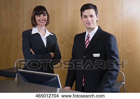 Picture - Portrait of two receptionists at the hotel reception. Fotosearch