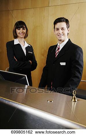 Stock Image - Portrait of two receptionists at the hotel reception. Fotosearch