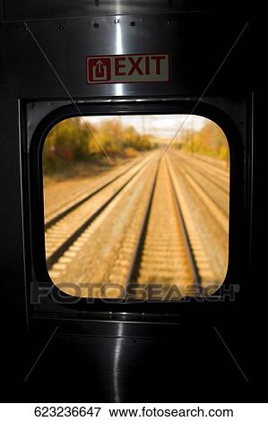 Stock Photo - Railroad track viewed through the window of a train. Fotosearch