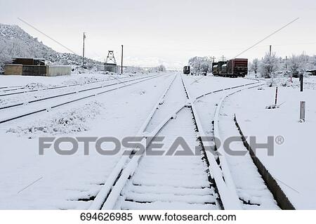 Railroad tracks covered with snow View Large Photo Image Stock Photography - Railroad tracks covered with snow. Fotosearch