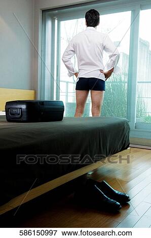 Rear view of a businessman with arms akimbo View Large Photo Image Stock Photo - Rear view of a businessman with arms akimbo. Fotosearch
