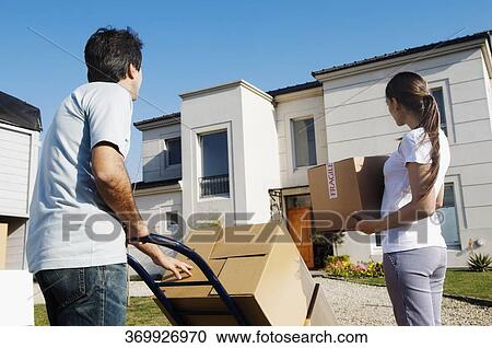 Rear view of a couple looking at a house View Large Photo Image Stock Image - Rear view of a couple looking at a house. Fotosearch