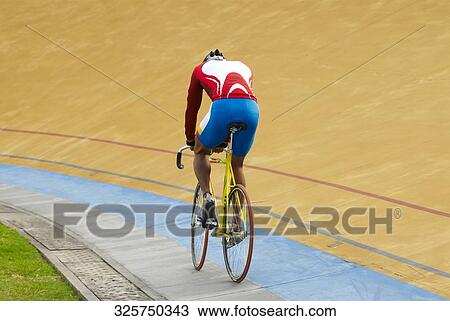 Rear view of a cyclist racing in velodrome View Large Photo Image Stock Image - Rear view of a cyclist racing in velodrome. Fotosearch