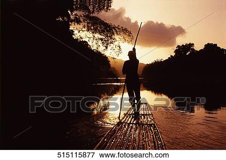 Rear view of a man guiding a bamboo raft View Large Photo Image Stock Photo - Rear view of a man guiding a bamboo raft. Fotosearch