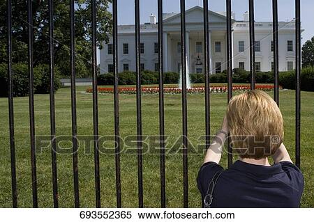 Stock Photography - Rear view of a woman looking at a government building, White House, Washington DC, USA. Fotosearch