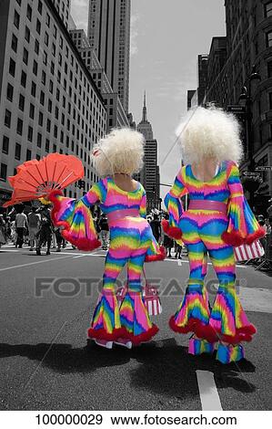 Rear view of two people in costume in a street, Gay Pride Parade, New York City, New York State, USA View Large Photo Image Stock Photo - Rear view of two people in costume in a street, Gay Pride Parade, New York City, New York State, USA. Fotosearch