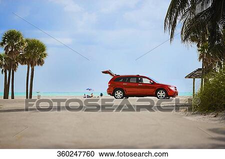 Red car on the beach View Large Photo Image Stock Image - Red car on the beach. Fotosearch