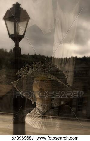 Stock Photo - Reflection of a mannequin on a glass window, Ghost Town, Virginia City, Montana, USA. Fotosearch