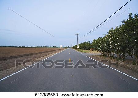 Stock Image - Road passing through a landscape. Fotosearch