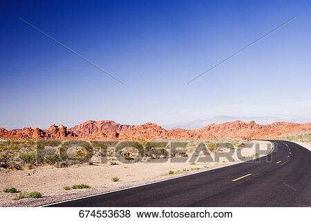 Road passing through an arid landscape, Las Vegas, Nevada, USA View Large Photo Image Stock Photo - Road passing through an arid landscape, Las Vegas, Nevada, USA. Fotosearch