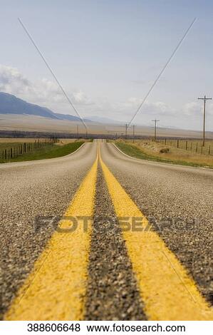 Stock Photo - Road passing through fields, Montana, USA. Fotosearch