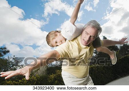 Senior man playing with his grandson View Large Photo Image Stock Image - Senior man playing with his grandson. Fotosearch
