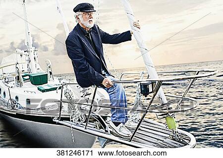 Senior man sitting on the ship's bow View Large Photo Image Stock Image - Senior man sitting on the ship's bow. Fotosearch