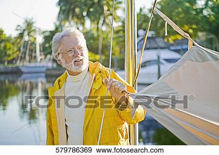 Senior man standing on a ship and thinking View Large Photo Image Stock Photo - Senior man standing on a ship and thinking. Fotosearch