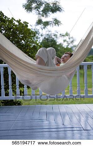 Senior woman lying in a hammock and thinking View Large Photo Image Stock Photo - Senior woman lying in a hammock and thinking. Fotosearch