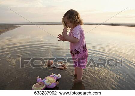 Side profile of a baby girl playing in water View Large Photo Image Stock Image - Side profile of a baby girl playing in water. Fotosearch