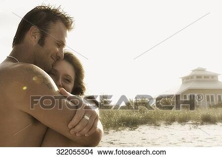 Side profile of a couple embracing each other View Large Photo Image Picture - Side profile of a couple embracing each other. Fotosearch